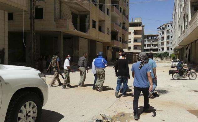 U.N. chemical weapons experts inspect one of the sites of an alleged poison gas attack in the southwestern Damascus suburb of Mouadamiya August 26 2013.