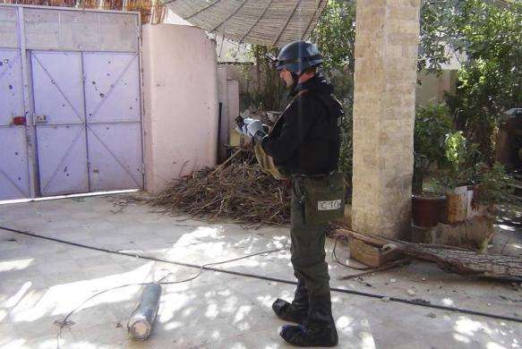 A U.N. chemical weapons expert gathers evidence at one of the sites of an alleged poison gas attack in the southwestern Damascus suburb of Mouadamiya August 26 2013.