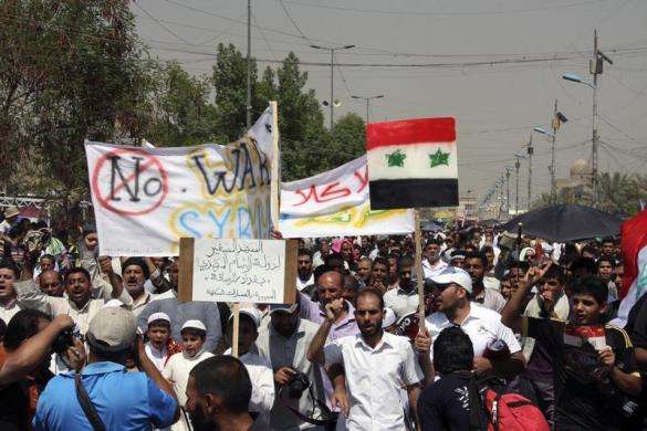Supporters of religious and political leader Muqtada al-Sadr demonstrate against the possibility of a U.S. military strike against the Syrian government in Baghdad Sadr City August 30 2013.