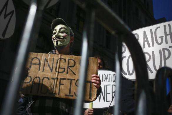Occupy Wall Street protesters stand outside a barricade at Zuccotti Park in New York September 17 2013.