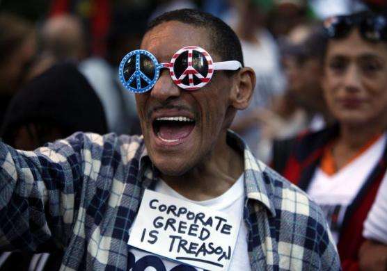 An Occupy Wall Street protester chants slogans along 47th Street in New York September 17 2013.