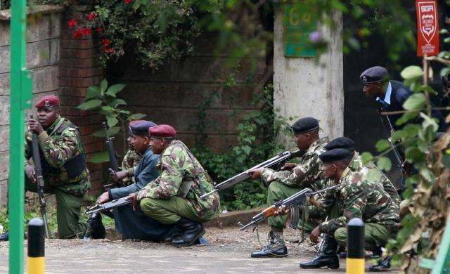 Kenyan police officers take position during the ongoing military operation at the Westgate Shopping Centre in the capital Nairobi September 23 2013.