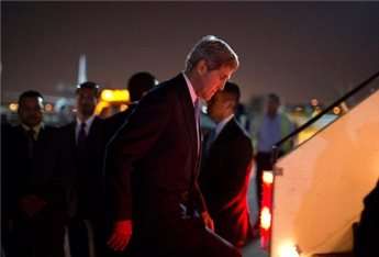 US Secretary of State John Kerry steps aboard his aircraft after meeting with members of Egypt