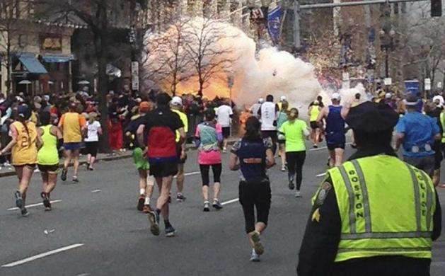 Two simultaneous explosions ripped through the crowd at the finish line of the Boston Marathon killing three people and injuring hundreds on a day when tens of thousands of people pack the streets to watch the world famous race. Runners continue to run t