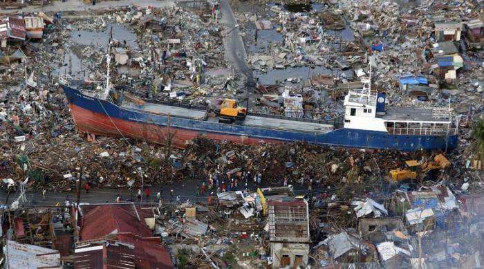 Super typhoon Haiyan reduced almost everything in its path to rubble when it swept ashore in the central Philippines on November 8 killing at least 6069 people leaving 1779 missing and 4 million either homeless or with damaged homes. Residents look at a 