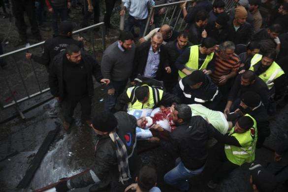 Civil defence personnel and people carry a wounded woman on a stretcher at the site of an explosion in Beirut southern suburbs January 2 2014.