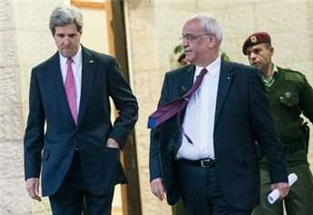 US Secretary of State John Kerry (L) and Palestinian negotiator Saeb Erekat leave after a meeting with Palestinian president Mahmud Abbas at the presidential compound Jan. 4, 2014, in Ramallah