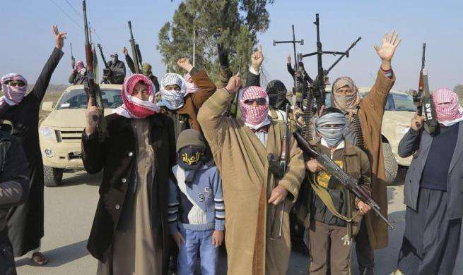 Tribal fighters gesture after deploying themselves on the streets of Ramadi January 6 2014.