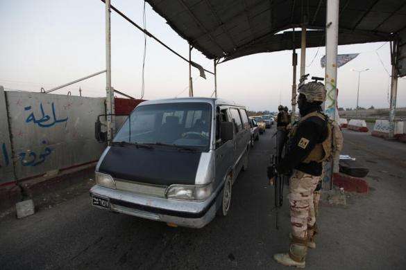 An Iraqi soldier stands guard at a check point west of Baghdad January 6 2014.
