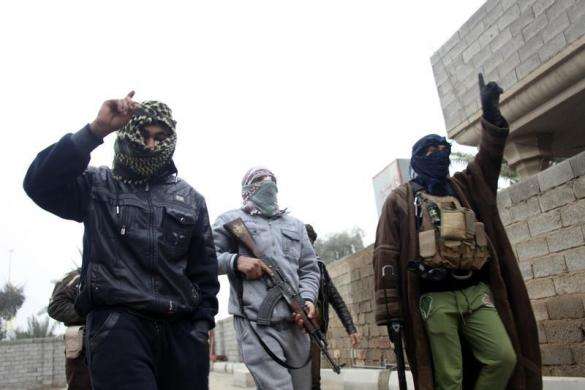 Gunmen fighters walk in the streets of the city of Falluja 31 miles west of Baghdad January 3 2014.