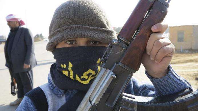 A boy holds his Kalashnikov rifle on the streets of the city of Ramadi January 6 2014.