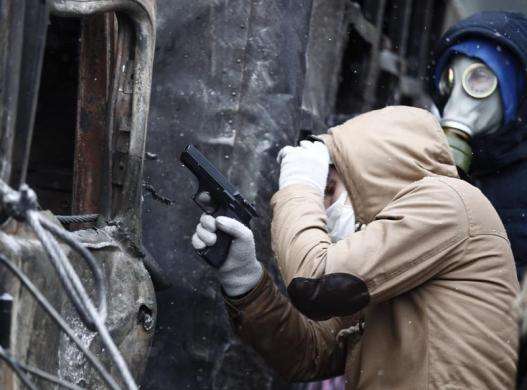 A pro-European protester holds a pneumatic gun during clashes with Ukrainian riot police in Kiev January 22 2014.