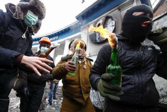 Pro-European integration protesters carry Molotov cocktails during clashes with police in Kiev January 20 2014.
