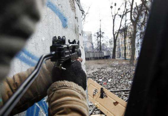 A pro-European integration protester aims his pneumatic gun towards riot police during clashes in Kiev January 20 2014.