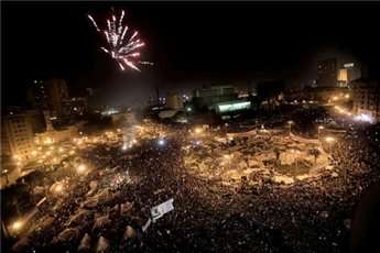 Picture dated February 11, 2011 shows Egyptian anti-government protesters celebrating under fireworks at Cairo
