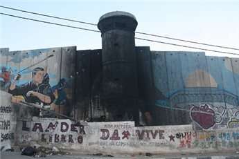 A watchtower along the Israeli separation wall along the main road of Aida camp.