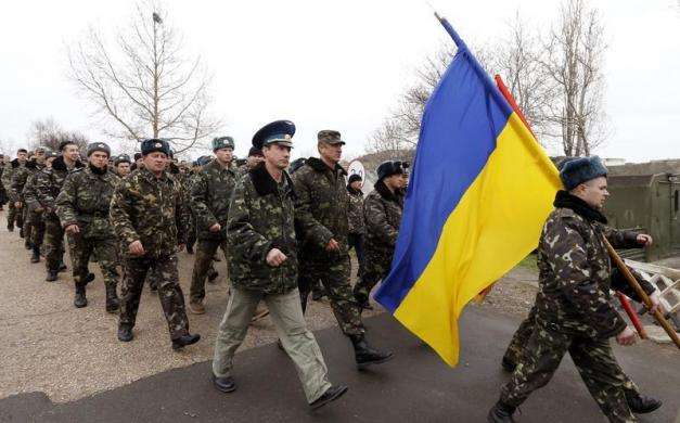 Ukrainian servicemen march away after negotiations with Russian troops at the Belbek Sevastopol International Airport in the Crimea region March 4 2014.