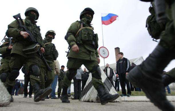 Military personnel believed to be Russian servicemen march outside the territory of a Ukrainian military unit in the village of Perevalnoye outside Simferopol March 4 2014.