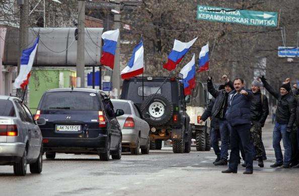 People react as cars with Russian and Crimean flags pass by in Simferopol March 2 2014.