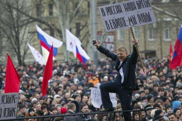 Pro-Russian protesters with Russian flags take part in a rally in central Donetsk March 1 2014. The banner reads 