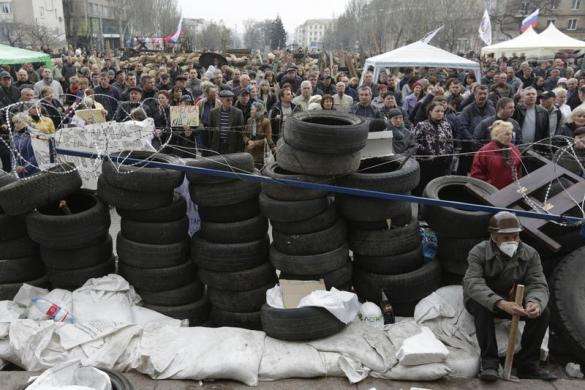 Pro-Russia protesters gather in front of a barricade outside a regional government building in Donetsk April 10 2014.