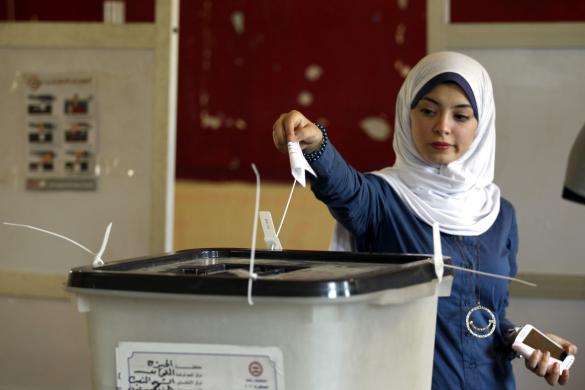 An Egyptian woman casts her ballot on the first day of voting in the presidential elections inside a polling station in Cairo May 26 2014.
