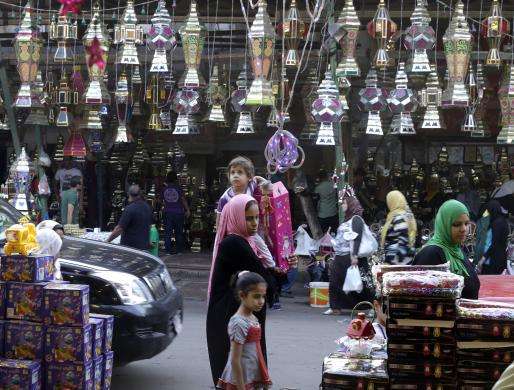 A child carried by his mother looks at traditional Ramadan lanterns known as fanous at a shop in Cairo June 26 2014.