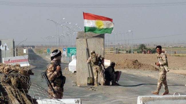 Kurdish Peshmerga forces man a checkpoint on the road leading from Kirkuk to the northern Iraqi city of Tikrit, June 30, 2014.
