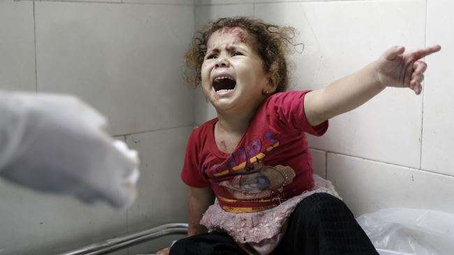 A Palestinian child, whose house was shelled by Israeli forces in Gaza City, at al-Shifa hospital, Gaza City, July 18, 2014