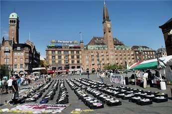 People look at symbolic child coffins during a pro-Palestinian protest on July 21, 2014, at City Hall Square in Copenhagen, Denmark