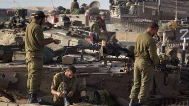 Israeli armored personnel carriers are stationed near Gaza Strip.