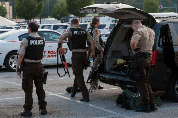 Police prepare their riot gear and weapons in anticipation of protests in Ferguson, Missouri, August 18, 2014.