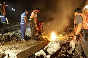 Palestinian rescuers clear the rubble of a destroyed house following an Israeli air strike in Gaza City on Aug. 19, 2014