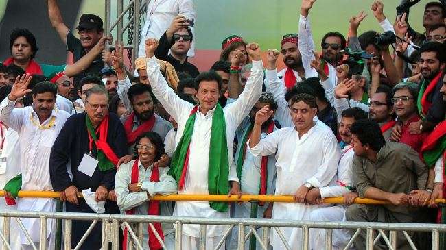 Pakistani cricketer-turned politician Imran Khan (C) gestures after arriving at an anti-government rally in Karachi, September 21, 2014.