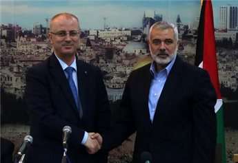 Hamas leader Ismail Haniyeh (right) shakes hands with Palestinian Prime Minister Rami Hamdallah in Gaza City, on Oct. 9, 2014