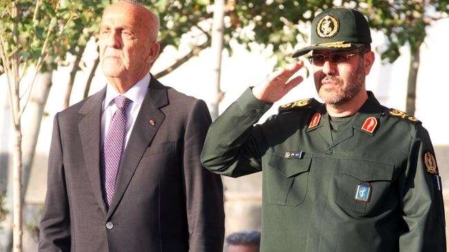 Iranian Defense Minister Brigadier General Hossein Dehqan (R) and his Lebanese counterpart, Samir Moqbel, listen to national anthems in Tehran on October 18, 2014.