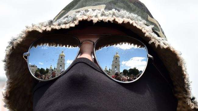 The Saint Sophia cathedral is reflected in the glasses of a new volunteer recruit of the Ukrainian army ‘Azov’ battalion, after a military oath ceremony in Kiev and before his contingent heads to eastern regions, June 23, 2014.