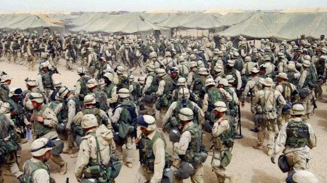 US troops in northern Kuwait gear up after receiving orders to cross the Iraqi border on March 20, 2003.