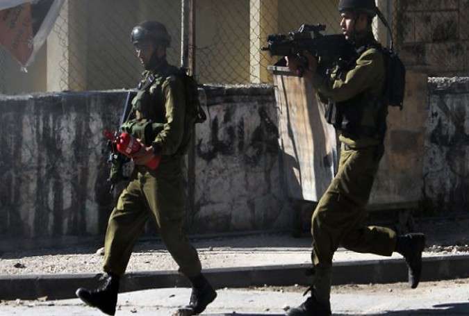 Israeli soldiers take position during clashes in the occupied West Bank city of Nablus.