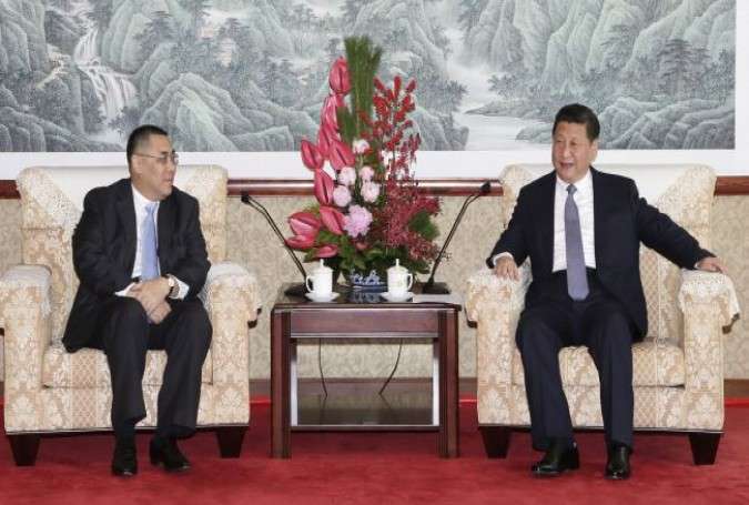 The photo shows Chinese President Xi Jinping (R) and Macau Chief Executive Fernando Chui On during a meeting in Macau on December 19, 2014.