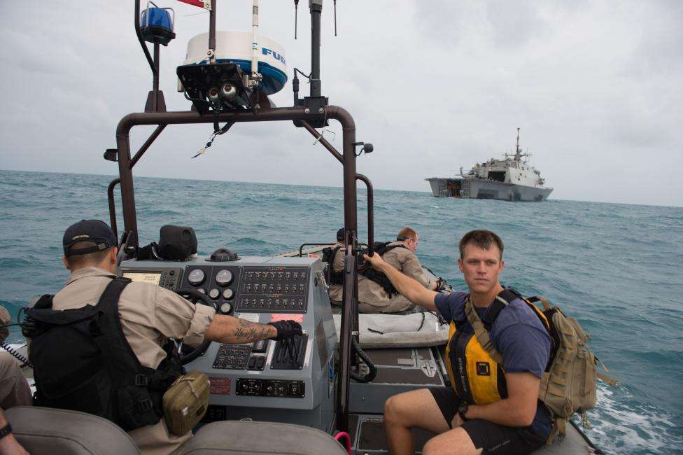 Sailors from the US Navy's USS Fort Worth searching in the Java Sea for AirAsia Flight QZ8501 make preparations to launch a Tow Fish side scan sonar system from the ship's 11-m rigid hull inflatable boat, January 4, 2015.
