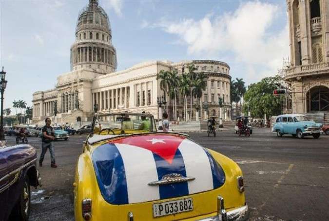 An old car with the Cuban flag painted on the trunk is seen near the Capitol of Havana, on January 7, 2015.