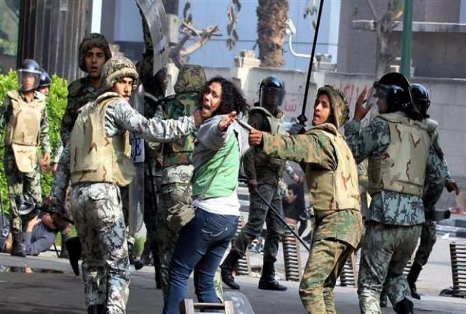 An Egyptian woman is taken by security forces during a protest in the capital Cairo.