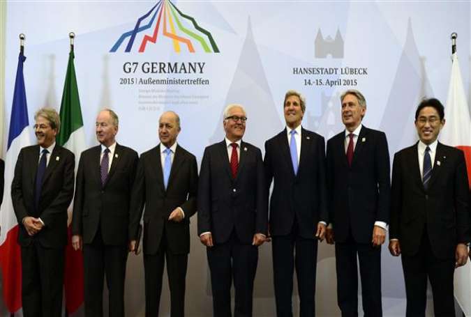 The foreign ministers of the US, Britain, Canada, France, Germany, Italy, and Japan pose for a photo during a G7 summit in Luebeck, Germany, April 15, 2015.