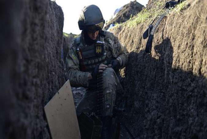A Ukrainian soldier prepares a machine gun in a position near the village of Shirokine, Donetsk region, on June 6, 2015.