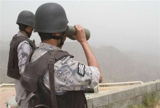 A Saudi border guard looking through binoculars at the Saudi-Yemeni borderline in southwestern Saudi Arabia on April 6, 2015.