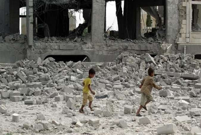 Yemeni children run amidst the debris of a house, destroyed in an airstrike by Saudi fighter jets, in the capital, Sana’a, on May 29, 2015.
