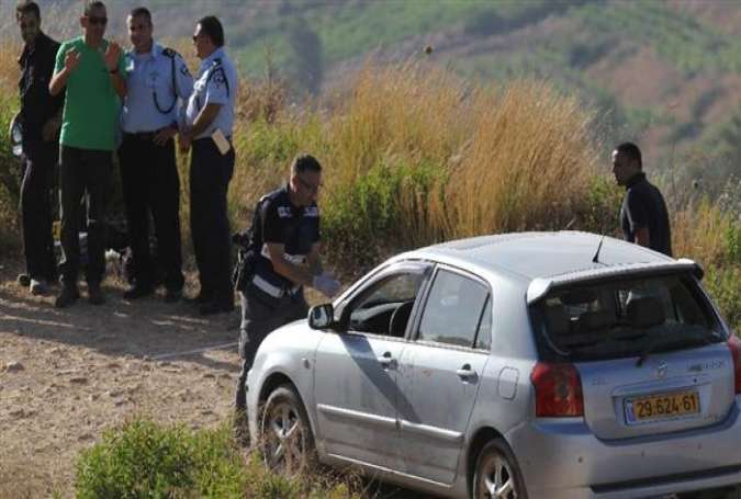 Israeli forensic police inspect a car belonging to Israelis near the illegal Dolev settlement in the occupied West Bank, June 19, 2015.