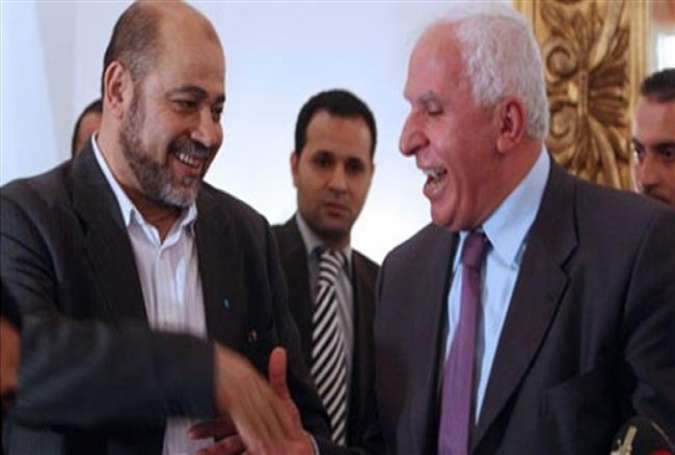 Hamas and Fatah delegation leaders Mussa Abu Marzuq (L) and Fatah Azzam al-Ahmad shaking hands after a meeting.