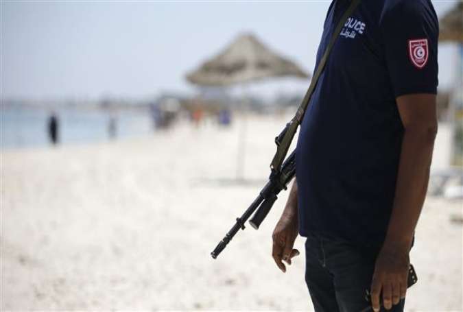 A Tunisian policeman patrols the beach in front of the Riu Imperial Marhaba Hotel in Port el Kantaoui, on the outskirts of Sousse south of the capital Tunis, on June 28, 2015, following a shooting attack two days earlier.